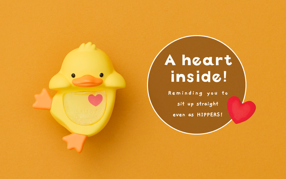Image set on yellow background. Duck variant Posture Pal Hipper on left with text on right "A heart inside! Reminding you to sit up straight even as HIPPERS! with a heart icon.