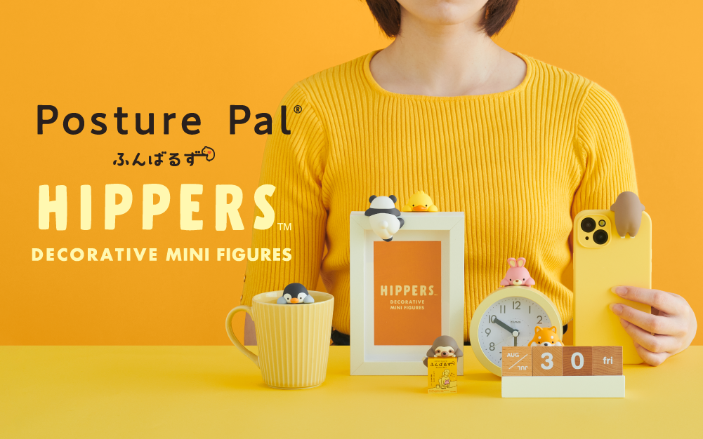 Set on yellow background, figure in yellow shirt sits with Posture Pal Hipper products. Text reads "Posture Pal Hippers Decorative Mini Figures" In front of figure from left to right: yellow mug with Penguin Posture Pal Hipper, white frame with orange text image "Hippers Decorative Mini Figures" with Panda Hipper facing away and Duck facing forward. In front of frame: Sloth Hipper, to the right a clock with Rabbit Hipper on top and Shiba Inu in front atop wooden block calendar and Sloth facing away on phone